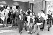 JEERING: Mama Jackey Maarohanye leaves the Protea magistrates' court on Monday surrounded by supporters after the charges against one of her students were withdrawn. Pic. Lucky Nxumalo. 2/05/2007. © Sowetan.