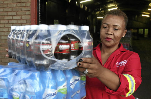 Verda Maluleka stands outside a warehouse she owns in Louis Trichardt, Makhado, which deals with the distribution of Coca-Cola beverages. / ANTONIO MUCHAVE