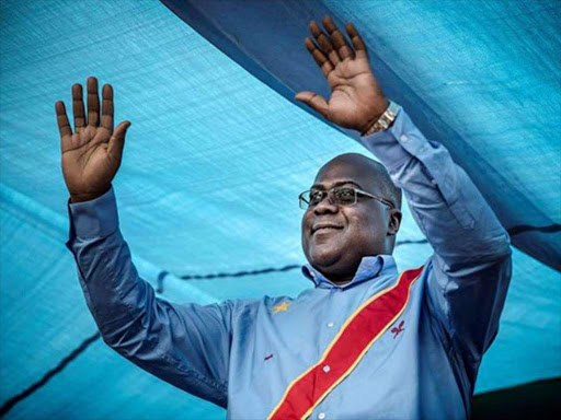 Felix Tshisekedi, the leader of the Union for Democracy and Social Progress (UDPS) waves to his supporters during a campaign rally in Kinshasa. COURTESY