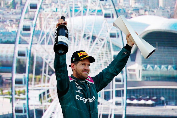 Second placed Sebastian Vettel of Germany and Aston Martin F1 Team celebrates on the podium after the F1 Grand Prix of Azerbaijan at Baku City Circuit on June 6, 2021 in Azerbaijan.