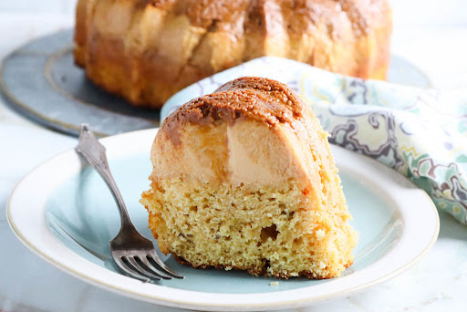 A slice of Eggnog Flan Cake on a plate.