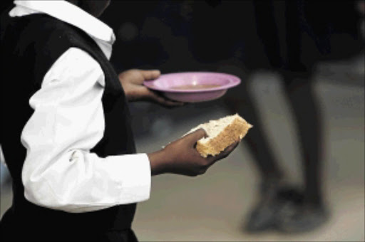 FILE PHOTO of a pupil after receiving food from school's feeding scheme.