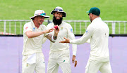 Faf du Plessis and Hashim Amla of South Africa congratulates team mate Dale Steyn on his catch during a match in Febraury 2019.  