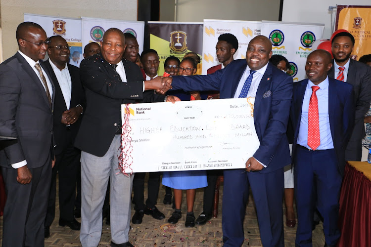 KMTC board chairperson Zachary Muburi-Muita, HELB chief executive officer Charles Ringera, KMTC chief executive officer Kelly Oluoch, National Bank of Kenya relationship manager Patrick Gachihi and HELB external resource mobilisation manager CPA James Gachari during the cheque handover ceremony.