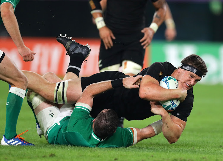 Scott Barrett of New Zealand is tackled by Peter O'Mahony of Ireland during the Rugby World Cup.