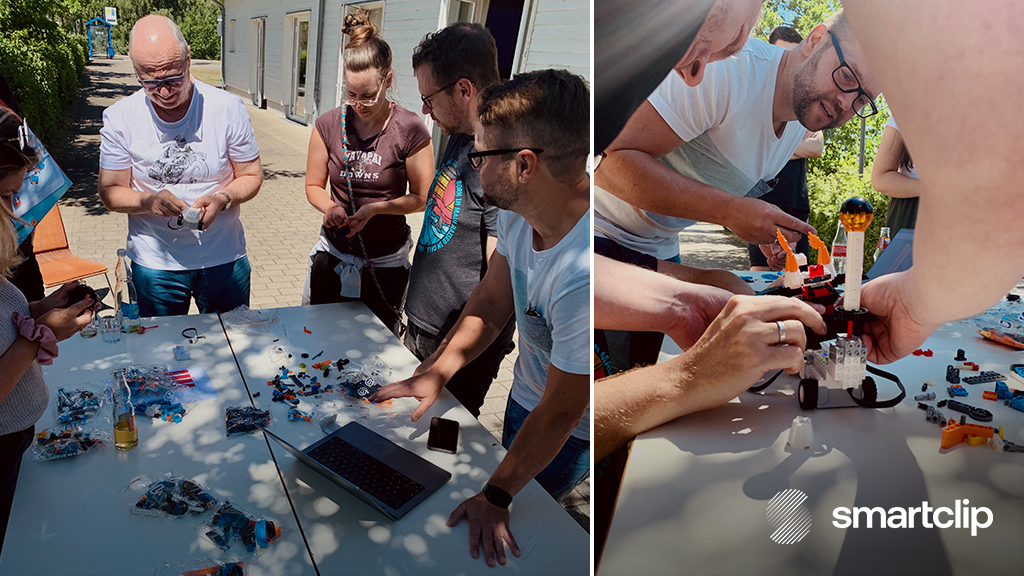 smartclip branded image of employees working together to build a LEGO robot.