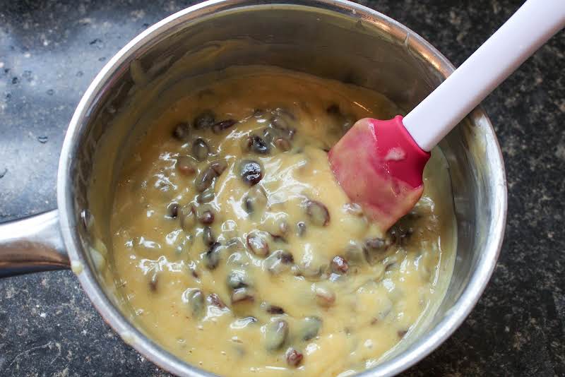 Egg Yolks, Sour Cream, Sugar, Corn Starch, Raisins, And Vanilla Whisked Together In A Saucepan.