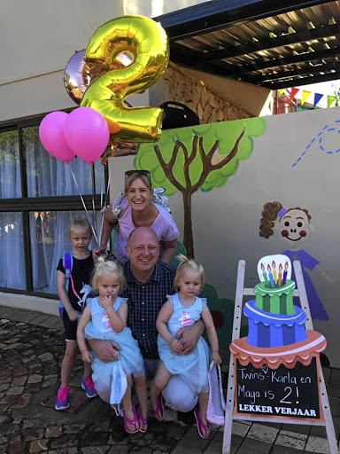 Lauren Dickason with her family when they were celebrating the twins' birthday. With her is her husband Graham, eldest daughter Liane and the twins, Maya and Karla.