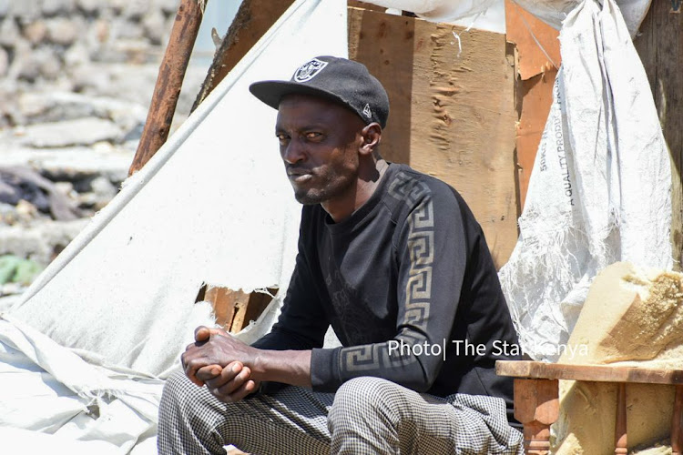 A man sits in deep thought next to his property at Mukuru Kwa Njenga slums on 22, November 2021./ MERCY MUMO