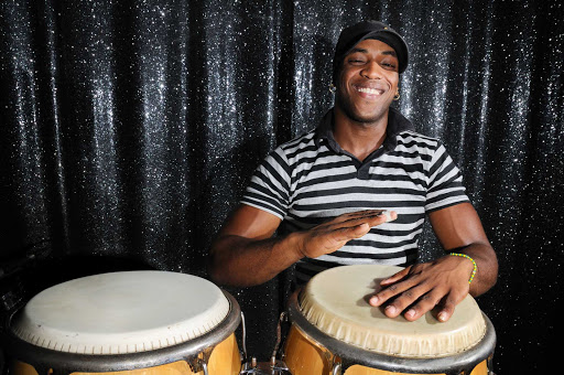 Cuba-Man-Playing-Bongos2.jpg - Fathom cruises to Cuba feature social and cultural opportunities, including sampling the local music.