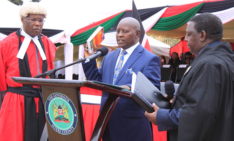 Judge James Wakiaga presides over the swearing in of Nyeri governor Mutahi Kahiga at the new Nyeri town main bus terminus at the Asian quarters Thursday