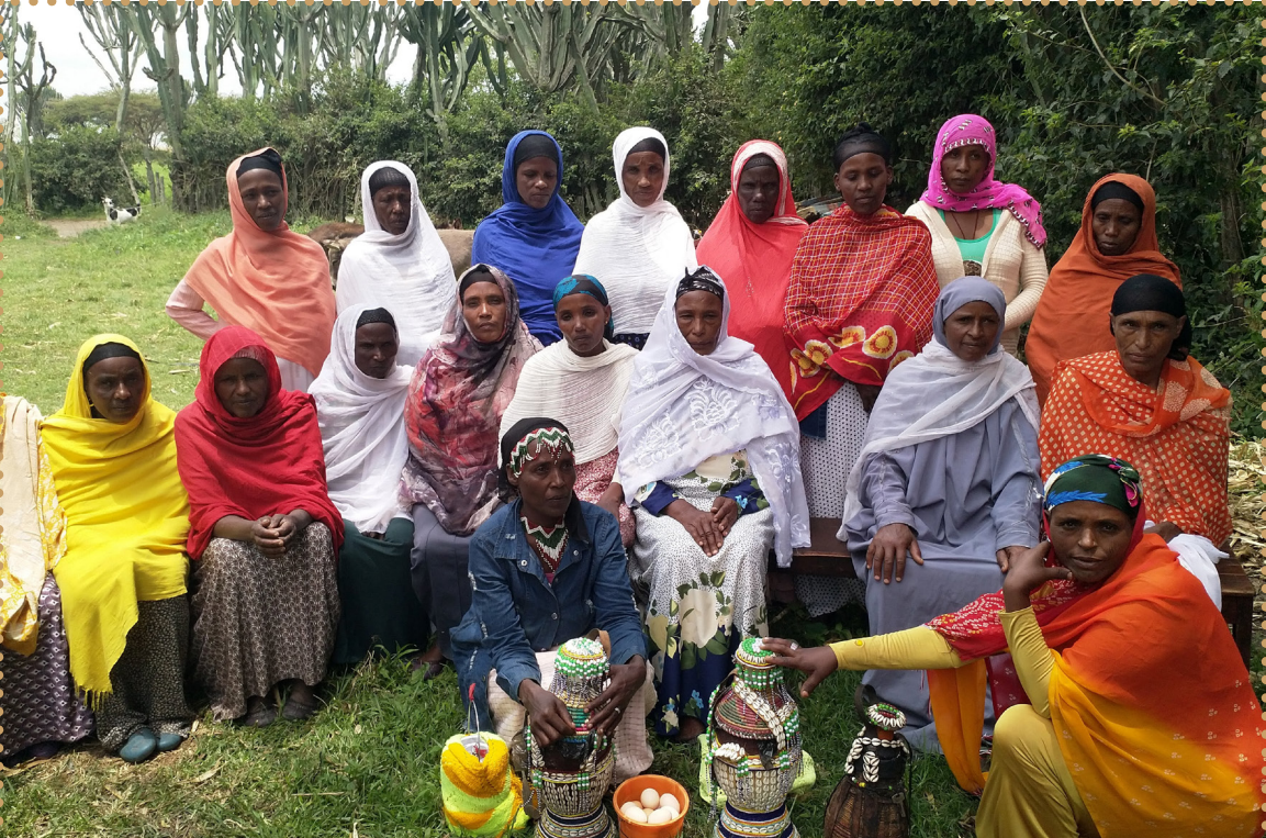 A group of people sitting on the groundDescription automatically generated with low confidence