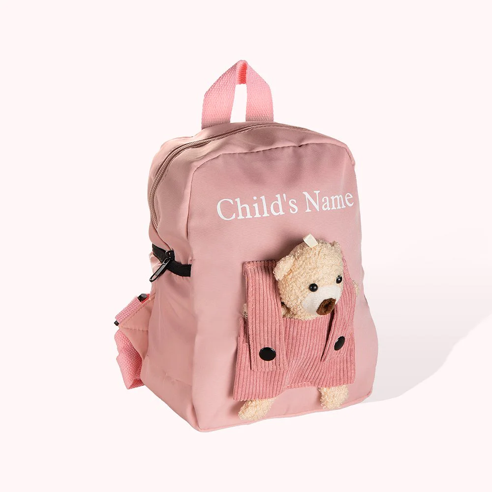 Sac à dos rose personnalisé avec un prénom et un ourson. 