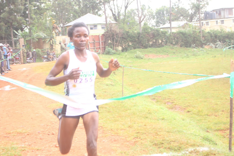 Faith Bett crosses the finishing line