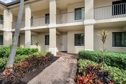 Apartment building facade with garden in this luxury apartment for sale in Naples ($739,000)