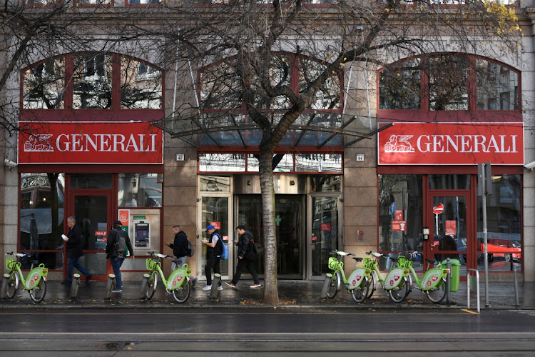 People walk past the headquarters of insurance company Generali in Budapest, Hungary. Picture: REUTERS/TAMAS KASZAS