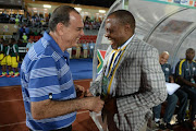 A file photo of then South Africa's coach Ephraim Mashaba (R) sharing a laugh with Ghana's coach Avram Grant (L) during the 2015 African Cup of Nations group C football match between South Africa and Ghana in Mongomo on January 27, 2015.