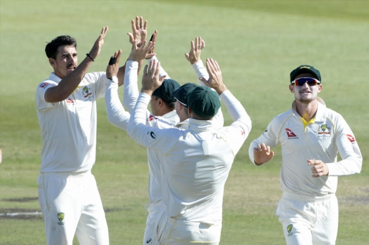 Mitchell Starc of Australia celebrates the wicket of Faf du Plessis of the Proteas with his team mates during day 2 of the 1st Sunfoil Test match between South Africa and Australia at Sahara Stadium Kingsmead on March 02, 2018 in Durban.