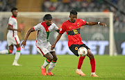 Jacinto Muondo Dala of Angola challenged by Cedric Badolo of Burkina Faso during their Africa Cup of Nations match at Charles Konan Stadium in Yamoussoukro.