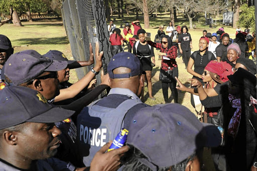 Tension broke out at the Union Buildings as women marchers tried to push their way through police at the gates.