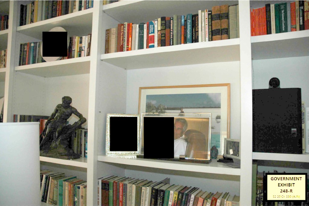 A bookshelf in the beachfront office with multiple photos of Epstein.