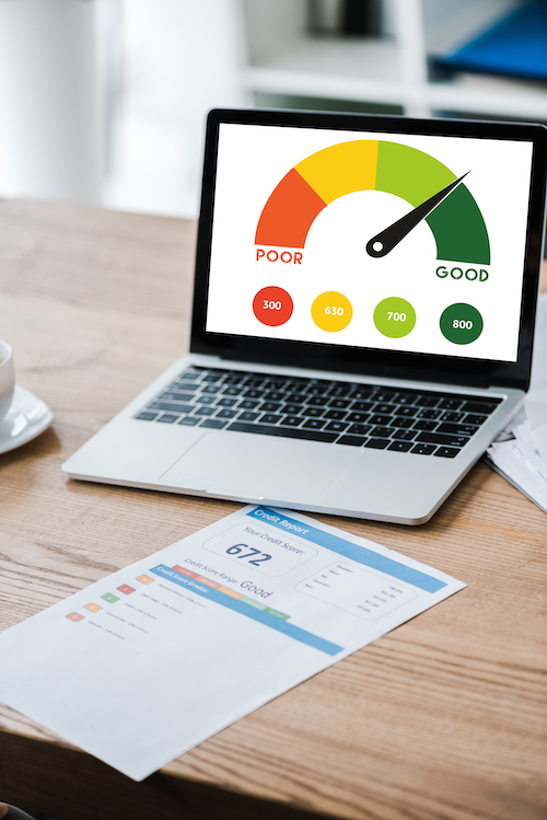 Laptop screen showing credit score impact of charge card vs credit card.