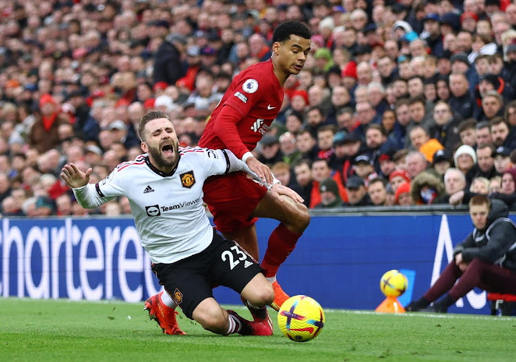 Manchester United's Luke Shaw in action with Liverpool's Cody Gakpo.