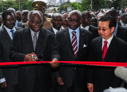 President Kibaki cuts the tape to officially open the Nairobi-Thika superhighway. Right, Chinese Ambassador Liu Guangyuan