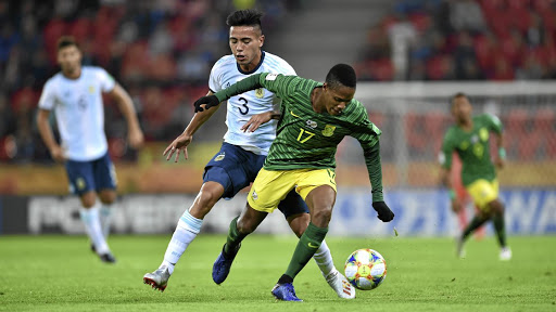 Luvuyo Phewa of SA evades Francisco Ortega of Argentina during their opening Fifa U20 World Cup match in Poland.