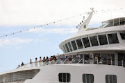 Tourists wave as the Europa passenger liner arrives in SA waters in Cape Town on November 30 2021. 