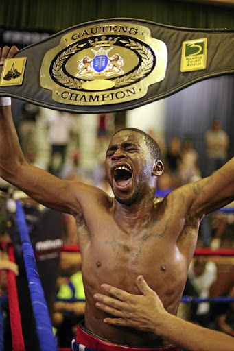 Jeff Magagane proudly poses with his Gauteng lightweight provincial belt. He's in action again tonight. /Nick Lourens