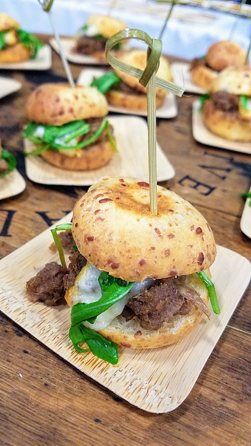 For the California Artisan Cheese Festival Best Bite, John Ash & Co took the Judge's Panel win for Best Bite with their Nicolau Farms Calabrian Chile Casiago and Niman Ranch pulled lamb belly slider with Capra Stanislaus cheese bun, Sparrow Lane raspberry pear vinaigrette dressed Red Dragon arugula