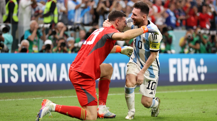 Emiliano Martinez and Lionel Messi of Argentina celebrate after the team's victory in the penalty shoot out during the FIFA World Cup Qatar 2022 quarter final match against Netherlands at Lusail Stadium on December 09, 2022 in Lusail City, Qatar.