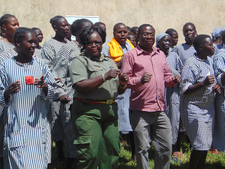 Officer in charge at the Eldoret Prison for women Eunice Odhiambo and director of the Center for Human Rights and Mediation Nick Omito with inmates on December 28.