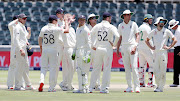 Ben Stokes celebrates with teammates after taking the wicket of Dean Elgar.