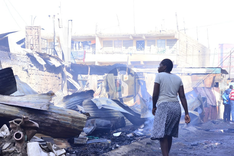 A woman walks past one of the areas affected by the gas explosion which has so far left three people dead and over 200 others injured in Embakasi, on February 2, 2024