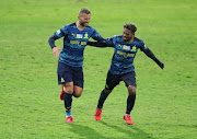 New Mamelodi Sundowns European striker Pavol Safranko (L) celebrates with teammate Kermit Erasmus (R) after scoring his first goal during the MTN8 first leg semi-final match against Lamontville Golden Arrows.