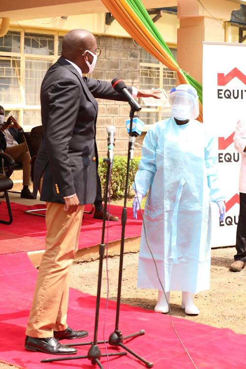 Polycarp Igathe showing out one of the samples brought in to help health workers to protect themselves from covid-19