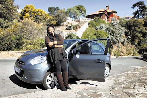 Itumeleng Motuba stands beside a funky Nissan Micra Picture: LAUREN MULLIGAN