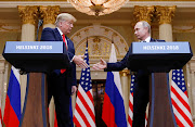 U.S. President Donald Trump and Russia's President Vladimir Putin shake hands during a joint news conference after their meeting in Helsinki, Finland, July 16, 2018. REUTERS/Kevin Lamarque/File Photo