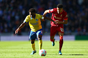 Tariq Lamptey of Brighton & Hove Albion battles for possession with Luis Diaz of Liverpool during their Premier League match at American Express Community Stadium on 12 March 2022.