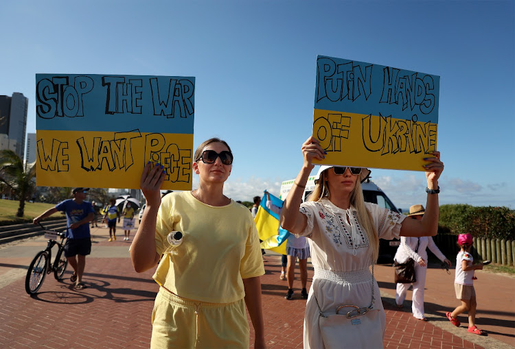 Protesters show slogans of support for Ukraine as the country enters day 11 of conflict with Russia