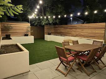 Cedar horizontal slat fencing complete with festoon lighting.  album cover