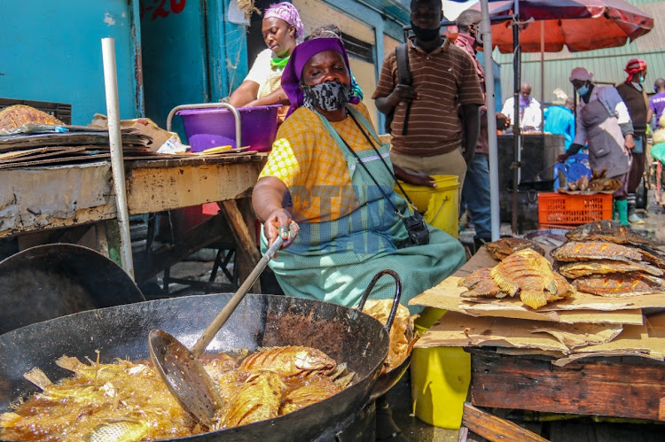 A trader sells fried fish at Gikomba on June 1, 2020.