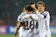 Germany's Thomas Müller (right) celebrates after his side's third goal, scored by İlkay Gündoğan during the 2022 World Cup qualifier against Armenia in Yerevan, Armenia.