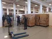 SARS officials seize a massive load of counterfeit cigarettes in a raid on traders in Cape Town.