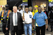 Sascoc second vice-president Les Williams, Minister of Sport Fikile Mbalula and Commonwealth Games Federation vice-president Gideon Sam with the Queens Baton at OR Tambo International Airport in Johannesburg. File photo.