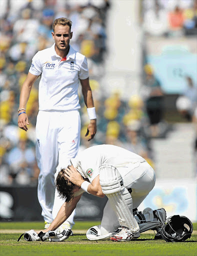 Shane Watson of Australia holds his head after being hit by a delivery from Stuart Broad of England during the 5th Test at the Oval in London yesterday