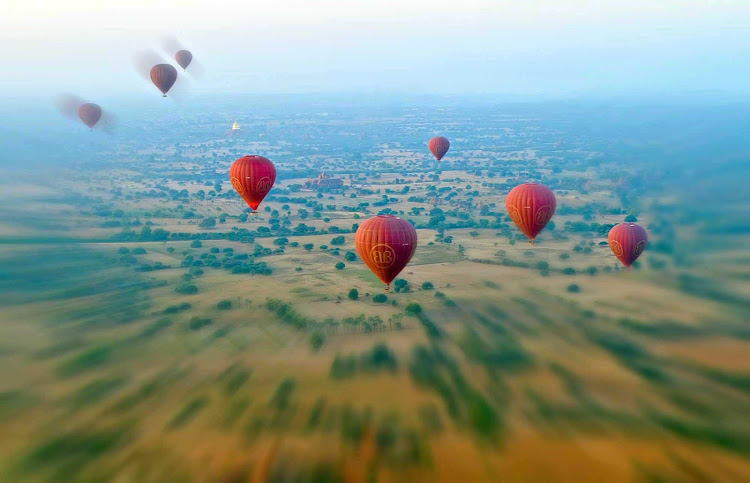 Hot air balloons sail over Bagan, Myanmar.