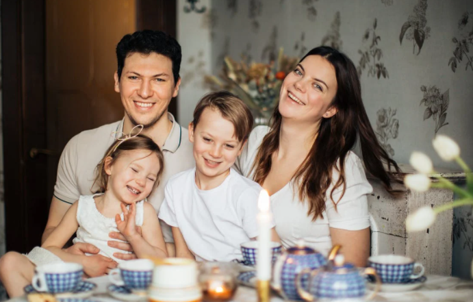 A family posing for a picture  Description automatically generated with medium confidence